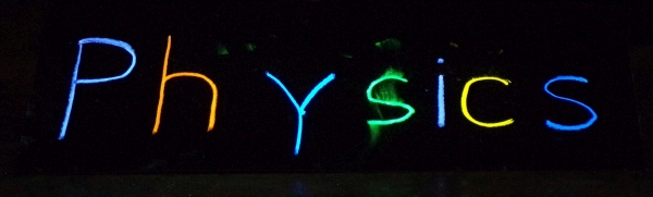 Physics sign written in fluorescent chalk