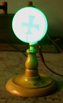 Crookes tube in operation, cross in the path of cathode rays